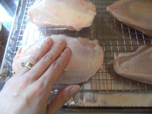 rubbing bone-in chicken breasts with oil