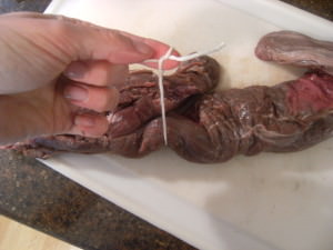 tying up a beef tenderloin for even cooking