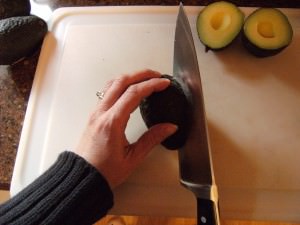 cutting an avocado for homemade guacamole