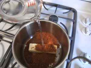 ingredients being mixed on the stove for a Texas sheet cake recipe