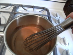 stirring chocolate in a sauce pan