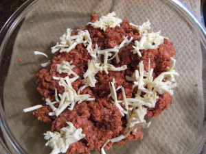 ground beef with shredded butter being mixed in.
