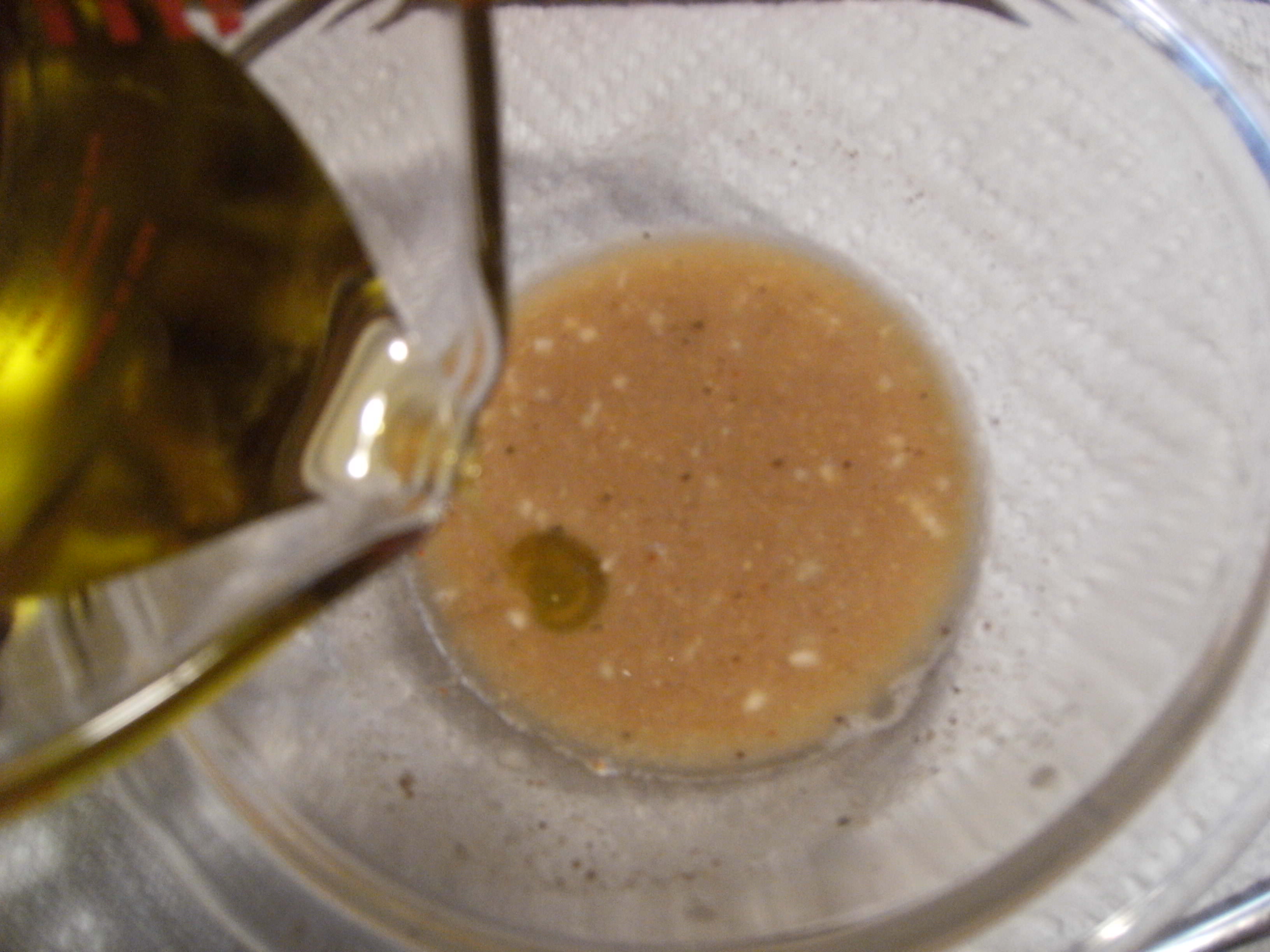 drizzle-olive-oil-and-whisk-to-emulsify-the-dressing