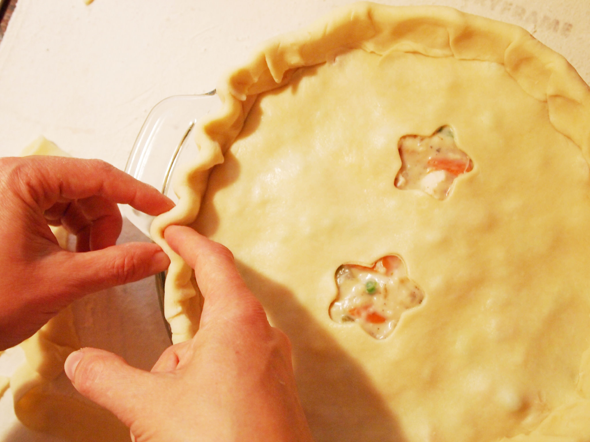 crimping the crust of a chicken pot pie