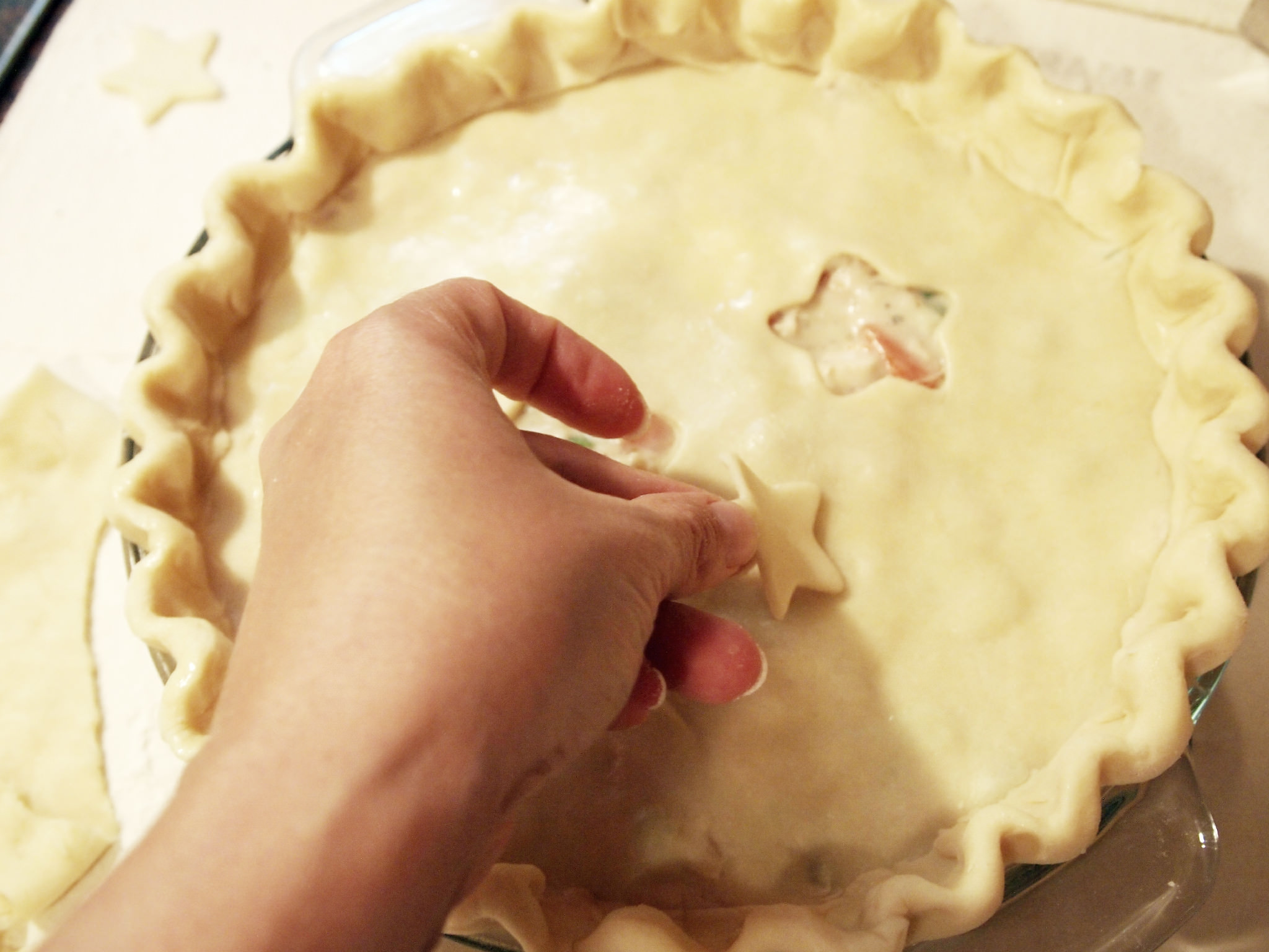 applying crust cut-outs to a chicken pot pie
