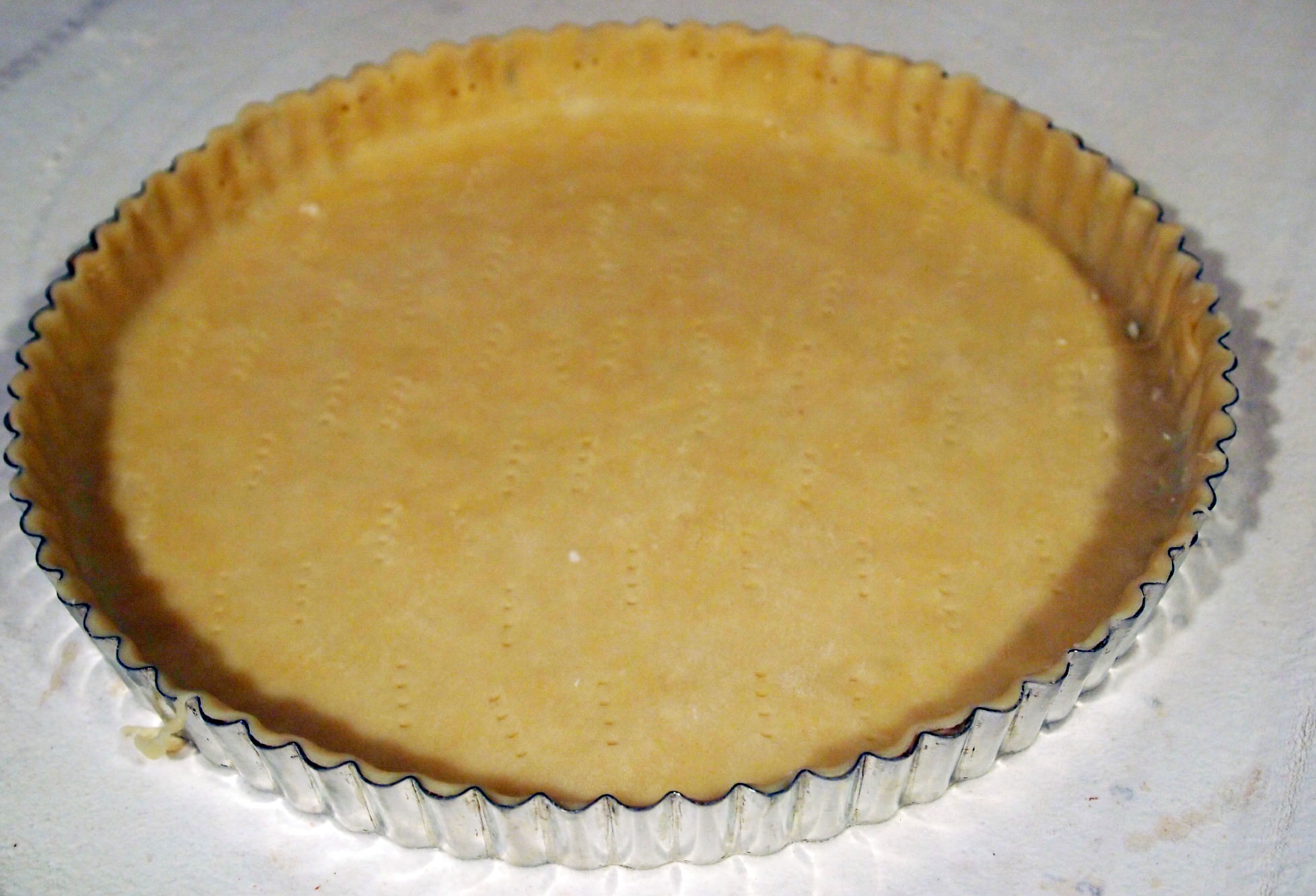 tart pan filled with pastry dough