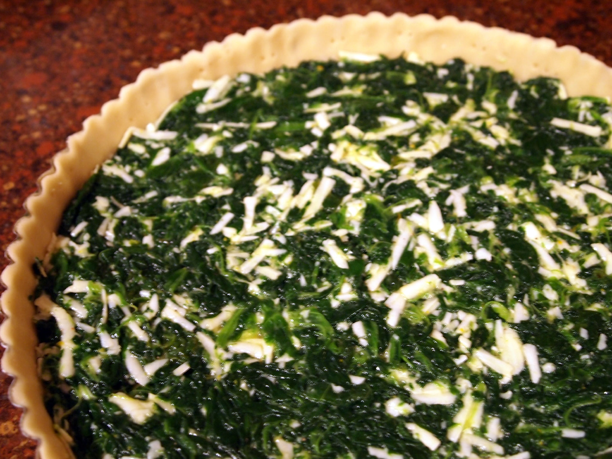 tart shell, filled with spinach and cheese filling