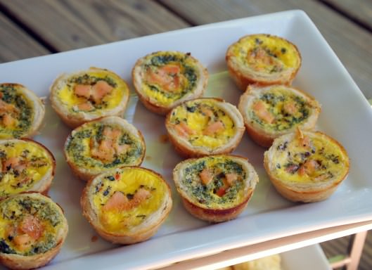 Smoked salmon quiche bites are the perfect appetizer or brunch treat. Two bites of smoked salmon, nestled in flaky pastry along with with herbed eggs, goat cheese, and dill. | ComfortablyDomestic.com