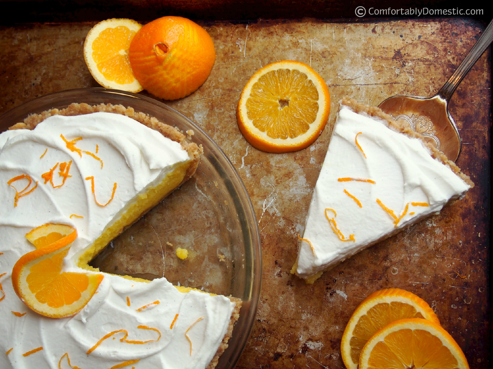 Orange cream pie is sweet-tart orange curd nestled on a Nilla wafer cookie crust, then topped with lightly sweetened whipped cream. | ComfortablyDomestic.com