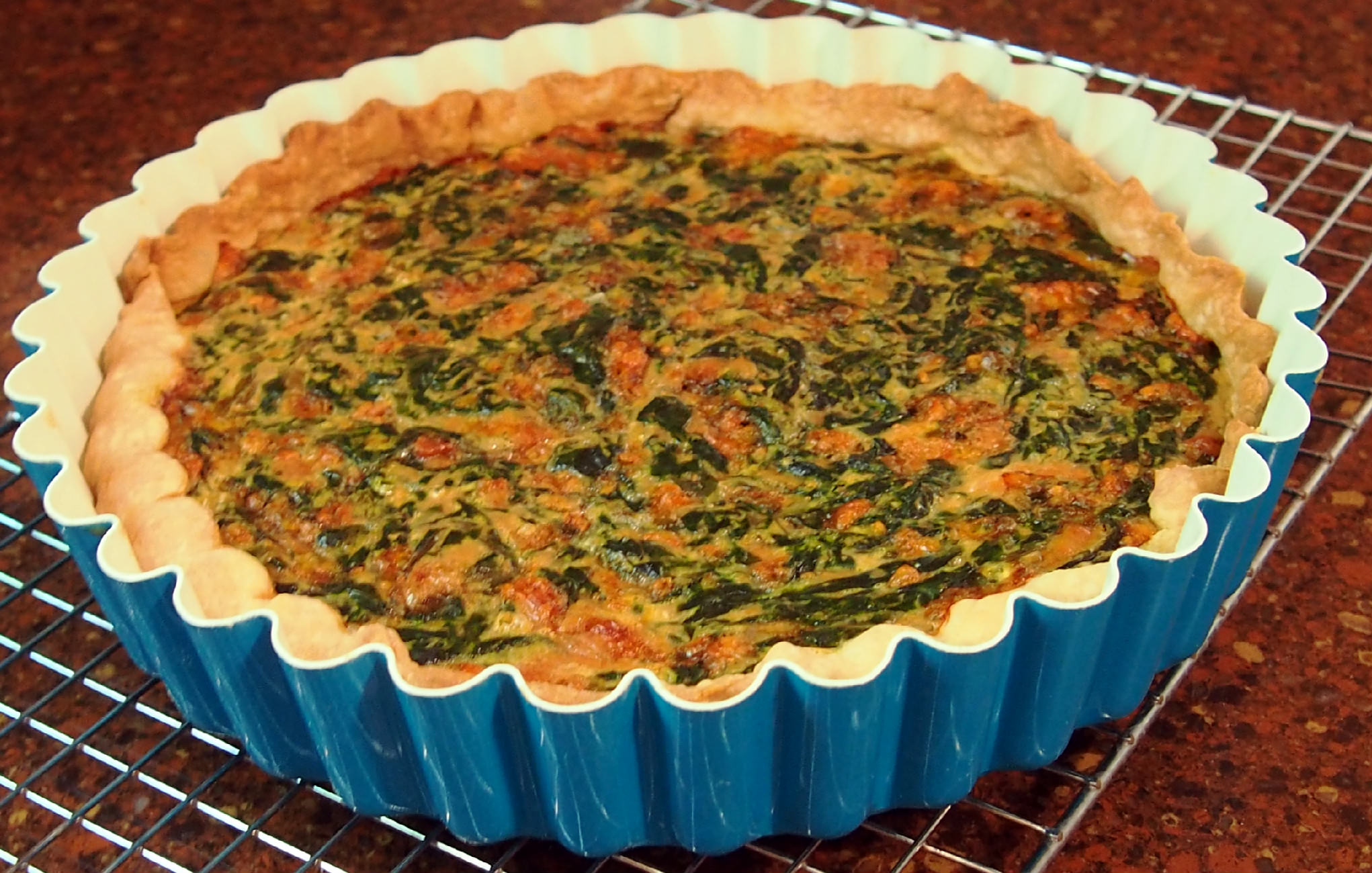 Fresh spinach, acquired through a CSA (Community Supported Agriculture) food co-op goes into making this egg-based, meatless, fresh spinach tart. | ComfortablyDomestic.com