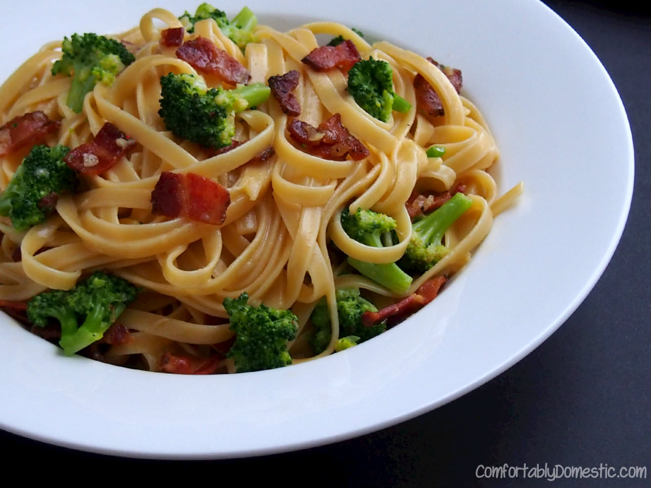 Broccoli bacon pasta carbonara is an inexpensive yet impressive meal, made with fresh broccoli, thick-cut pepper bacon, eggs, and plenty of cheese. | ComfortablyDomestic.com