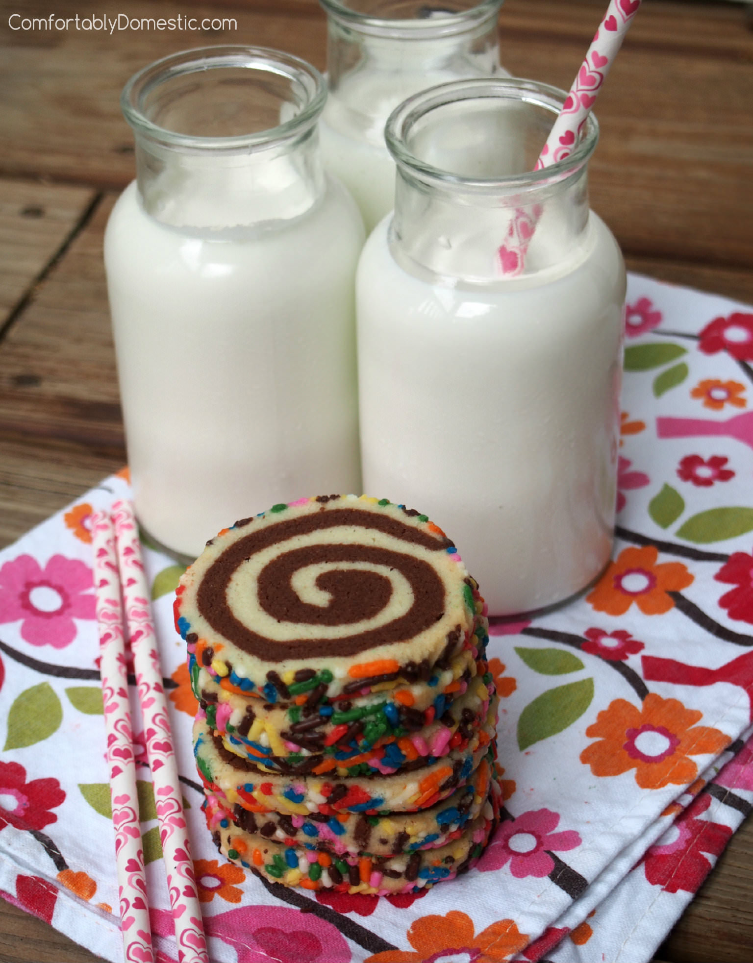 Shortbread pinwheels, also known as happiness cookies, are buttery vanilla and chocolate shortbread cookies presented in a fun pinwheel design, with colorful sprinkles for an added touch of whimsy. | ComfortablyDomestic.com