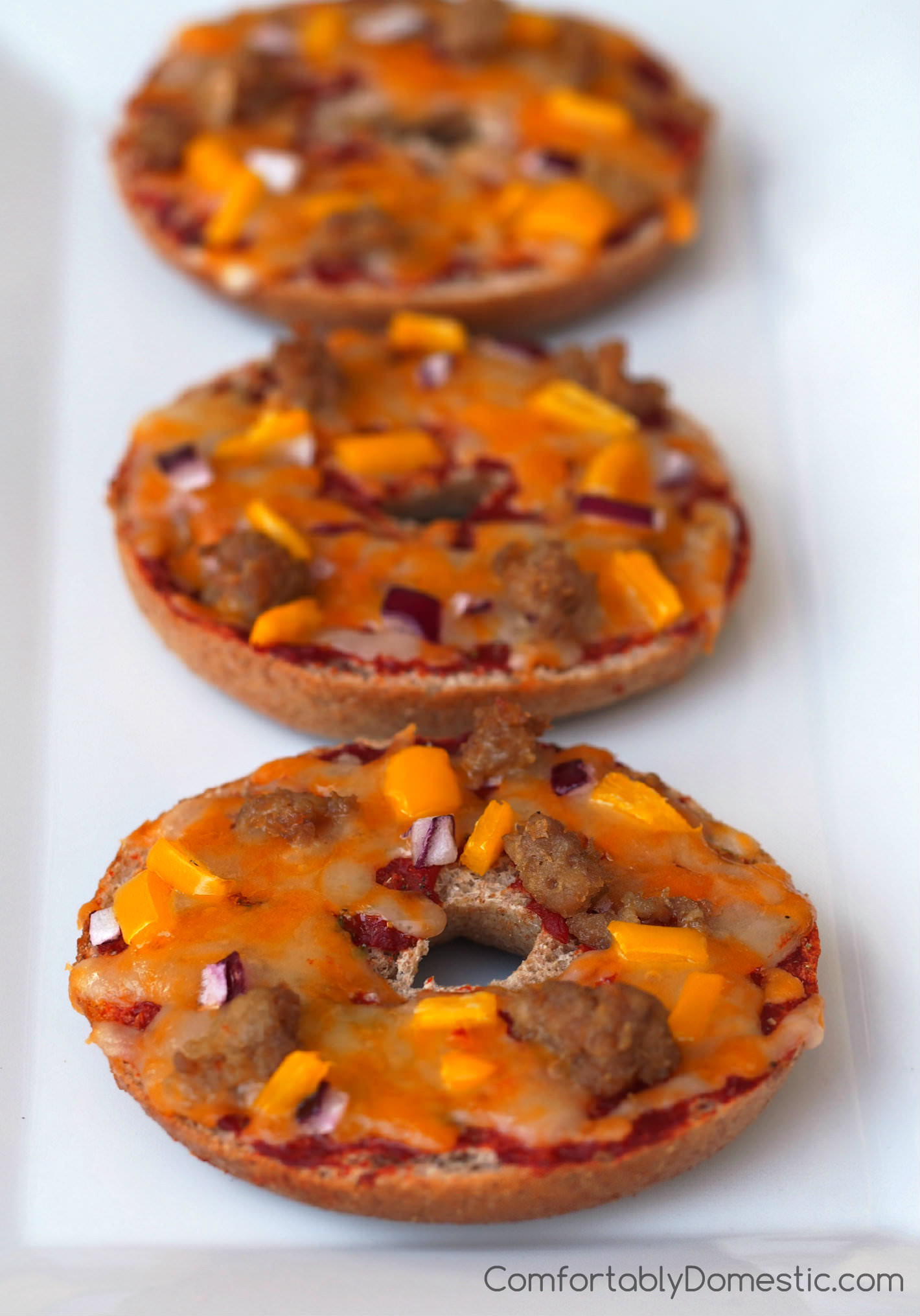 Copy Cat Bagel Bites - Whole grain bagels topped with wholesome toppings like cheddar-jack cheese, lean turkey sausage, and a mix of vegetables for a fun and balanced lunch. Bagel Bites may also be assembled ahead and frozen for a quick after school snack. | ComfortablyDomestic.com