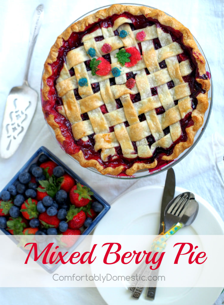 Mixed berry pie that is as delightfully inviting as summer itself. Fresh, sweet strawberries, juicy blueberries, and tart raspberries happily mingle together in a flaky pastry crust.  | ComfortablyDomestic.com
