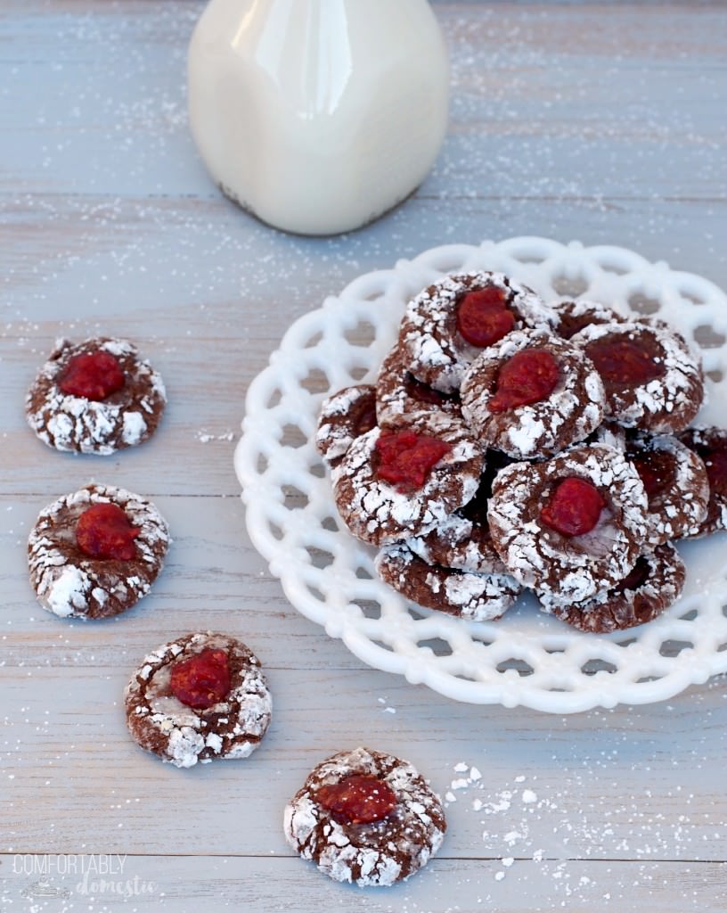 Chocolate thumbprint cookies are the perfect Christmas cookie! Tangy raspberry jam, cradled in lush chocolate cookie dough, coated with a heavy dusting of powdered sugar. They're a sweet cookie that virtually melts on the tongue. | ComfortablyDomestic.com