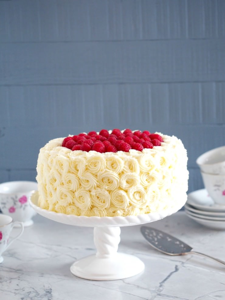 Vanilla-Buttermilk-Cake is an extra moist vanilla cake that is sure to impress when filled with raspberry and lemon, and enrobed in dreamy white chocolate buttercream frosting.