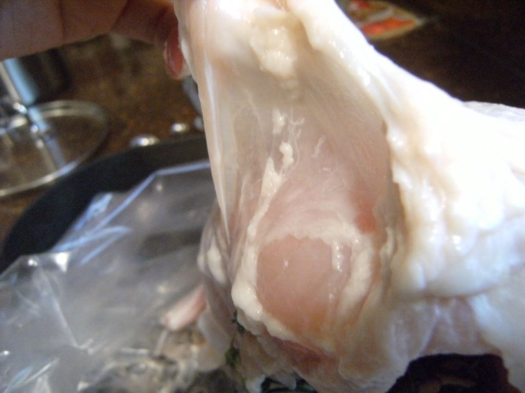 Break the membrane of the skin on a turkey breast to make a pocket