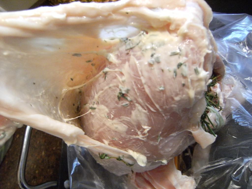 rubbing compound butter onto turkey breasts