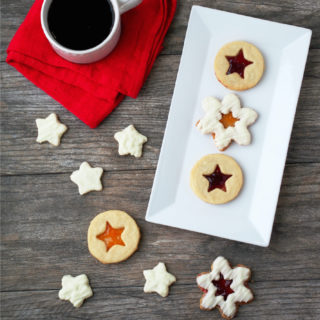 Shortbread-Linzer-Cookies are rich buttery shortbread cookies with a thin layer of preserves sandwiched between them to look like linzer cookies. They're as beautiful as they are delicious!