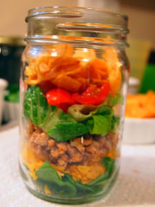 A lightened up version of walking tacos, these are made with ground turkey instead of ground beef. Served in mason jars for extra portability and fun! | ComfortablyDomestic.com
