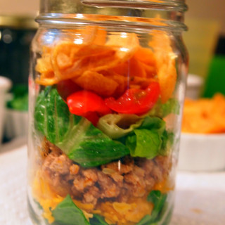 A lightened up version of walking tacos, these are made with ground turkey instead of ground beef. Served in mason jars for extra portability and fun! | ComfortablyDomestic.com