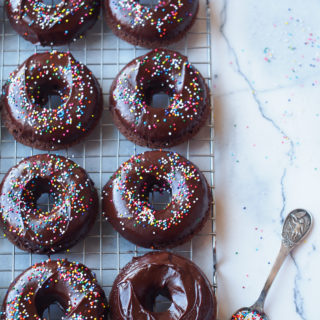Chocolate Sour Cream Doughnuts with chocolate ganache and colorful sprinkles.