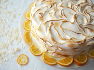 The balance of flavors and textures between moist cake, creamy lemon curd, and toasted Swiss meringue makes this Coconut Meyer Lemon Cake recipe a winner! | ComfortablyDomestic.com