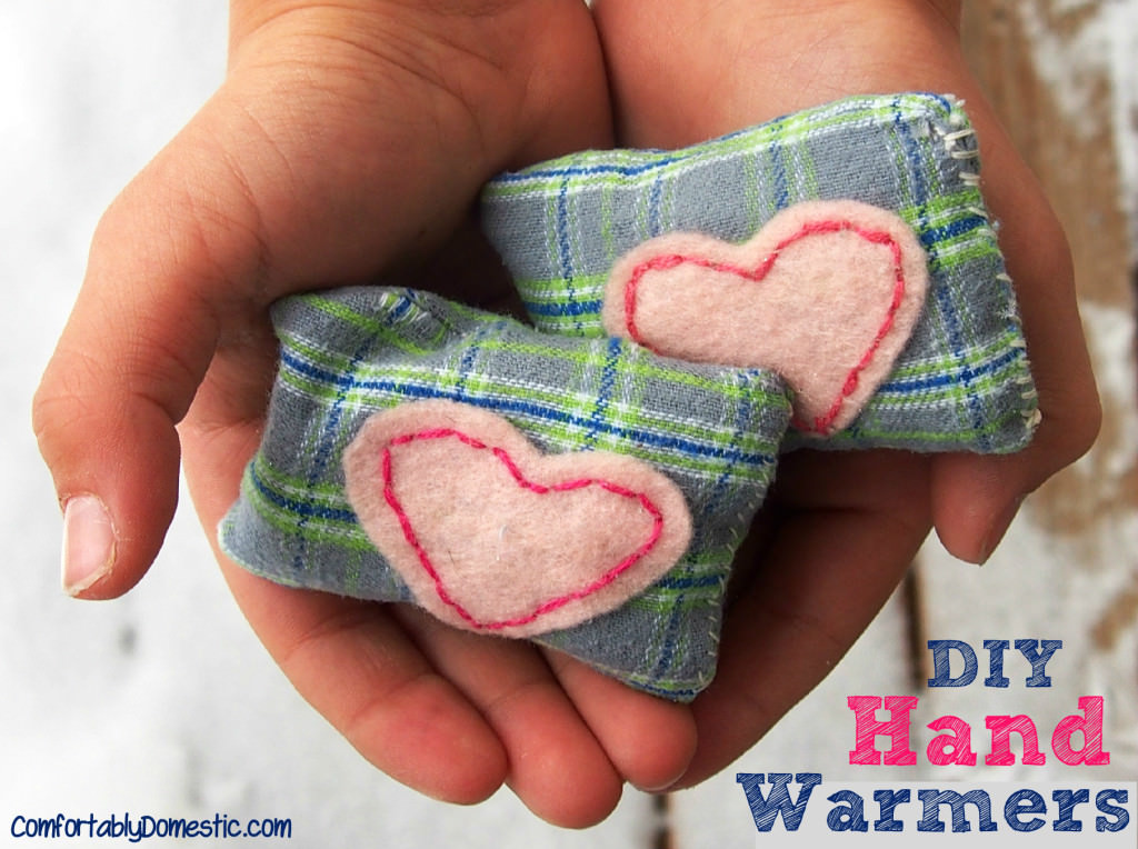 Two DIY microwavable hand warmers held in the palm of kid hands.