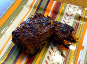 Sweet and Smoky Baby Back Ribs with Homemade BBQ Sauce | ComfortablyDomestic.com - Baby back ribs with homemade BBQ sauce. Not much tastes better off of the grill on a holiday weekend! Tender pork ribs mopped with a sweet and smoky sauce that's finger lickin', lip smackin' delicious!