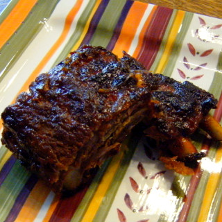 Sweet and Smoky Baby Back Ribs with Homemade BBQ Sauce | ComfortablyDomestic.com - Baby back ribs with homemade BBQ sauce. Not much tastes better off of the grill on a holiday weekend! Tender pork ribs mopped with a sweet and smoky sauce that's finger lickin', lip smackin' delicious!