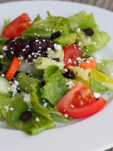 Black beans, crisp greens, fresh vegetables, and Cotija cheese, brightly dressed in a simple lemon vinaigrette. This is a delicious healthy salad recipe!