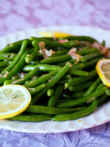 Garlic green beans are a delicious, easy to make holiday side dish! Fresh green beans are lightly steamed and tossed with a bright, lemon garlic butter sauce with caramelized shallots. | Get the recipe from ComfortablyDomestic.com