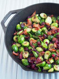 Pan seared Brussels sprouts are a healthy side dish, ready in minutes! Bright, earthy Brussels sprouts are caramelized with a touch of bacon and topped with tangy dried cranberries. | ComfortablyDomestic.com