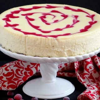 Cranberry Swirl Cheesecake - Thick, rich, and super creamy cheesecake adorned with a tangy swirl of fresh cranberries makes dessert a perfectly decadent experience. | ComfortablyDomestic.com