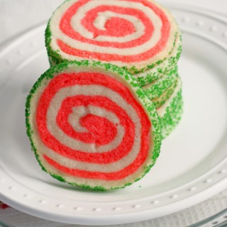 Peppermint shortbread pinwheel cookies are the perfect cookie recipe to make for your holiday cookie platter! Buttery vanilla and peppermint shortbread, presented in a fun pinwheel design. Edged in colored sugar, for an added touch of holiday sparkle. | ComfortablyDomestic.com