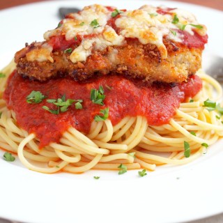 Baked-Chicken-Parmesan - Baked Chicken Parmesan takes a lighter spin, using economical chicken thighs coated in seasoned bread crumbs, drizzled with butter, and then baked until crisp. The crunchy, juicy chicken is finished with a touch marinara and parmesan cheese for that classic, comforting flavor with fewer calories. | ComfortablyDomestic.com