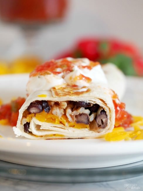 Crispy-Black-Bean-Burritos combine black beans with sautéed vegetables, brown rice, and cheddar cheese for a healthy, balanced vegetarian meal with complete proteins, all wrapped in a toasted tortilla.