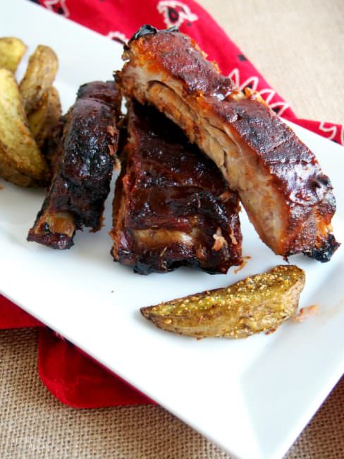 Perfect Barbecued Ribs are slow roasted and finished on the grill with a sticky-sweet sauce, for ribs that are fall-off-the-bone tender.