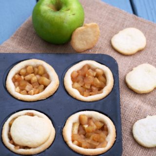 Mini-Apple-Shortbread-Pies marry ripe, juicy apples with cinnamon sugar for a delightful pie filling nestled in a buttery cookie crust. These individual apple pies are full of all the comforts of fall.