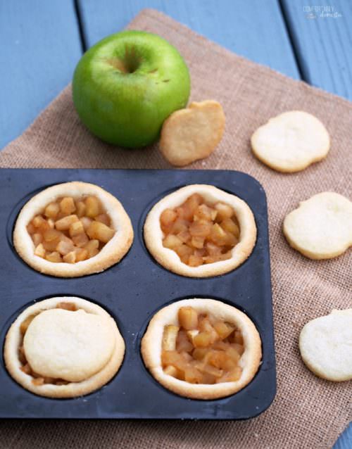 Mini-Apple-Shortbread-Pies marry ripe, juicy apples with cinnamon sugar for a delightful pie filling nestled in a buttery cookie crust. These individual apple pies are full of all the comforts of fall.