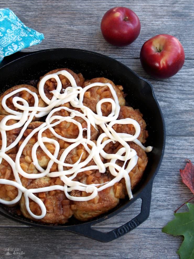 Apple-Pie-Angel-Biscuits are southern style biscuits baked in a cast iron skillet and topped with cinnamon apple pie filling and elegant drizzle of gooey cream cheese icing.