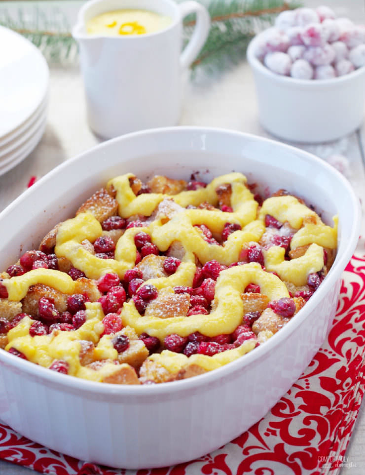 Cranberry-Orange-Bread Pudding is a simple, classic dessert all dressed up with fresh cranberries and a hint of orange for the holidays! Topped with a simple orange custard sauce, Cranberry Orange Bread Pudding is proof that leftover bread can easily be transformed into a delicious dessert.
