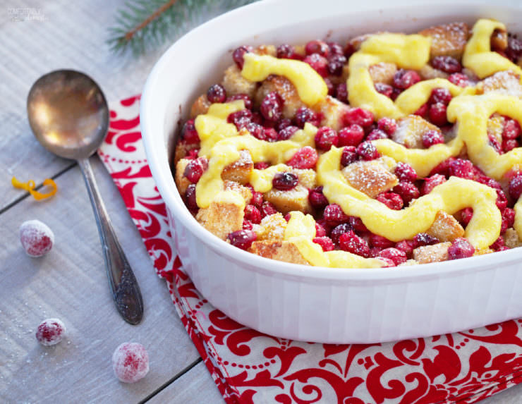 Cranberry-Orange-Bread Pudding is a simple, classic dessert all dressed up with fresh cranberries and a hint of orange for the holidays! Topped with a simple orange custard sauce, Cranberry Orange Bread Pudding is proof that leftover bread can easily be transformed into a delicious dessert.