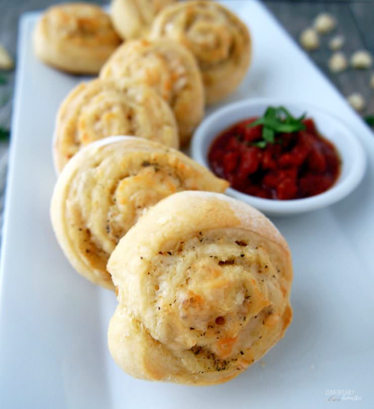 Cheesy-Italian-Herb-Pinwheels are buttery biscuits rolled with Italian seasoning and plenty of cheese for a savory three-bite appetizer that everyone will enjoy.
