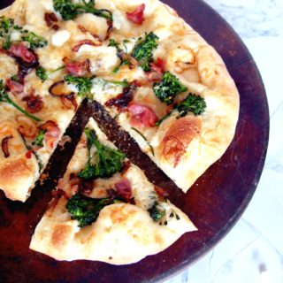 Prosciutto-and-Broccolini-Pizza proves that simple pizzeria style pizza is easily made at home! The chewy, thin crust pizza dough brushed with garlic butter, then topping it salty prosciutto, earthy broccolini, sweet caramelized onions, and shaved Asiago cheese is a taste to behold.