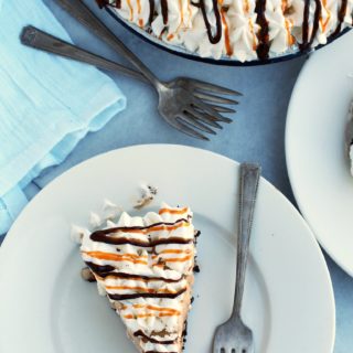 Mocha-Cappuccino-Ice-Cream-Pie is a winning, no bake summer dessert! This decadent pie is comprised of coffee ice cream, chocolate chips, sweetened whipped cream, drizzles of caramel and hot fudge, nestled in an Oreo cookie crust.