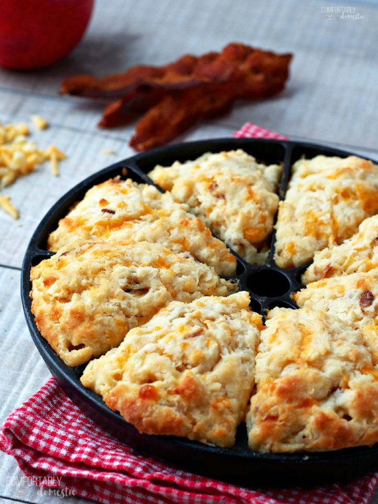 A close up photo of Apple Cheddar Bacon Scones in a cast iron pan. 