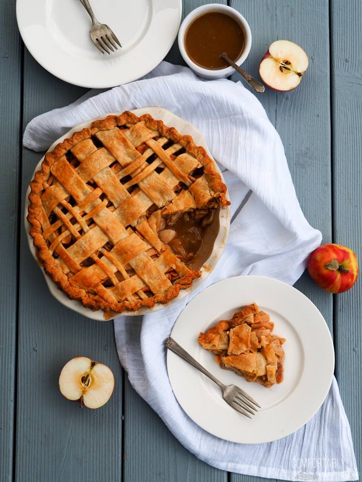 whole-caramel-apple-pie-with-lattice-crust-and-one-slice-on-a-white-plate-with-fork