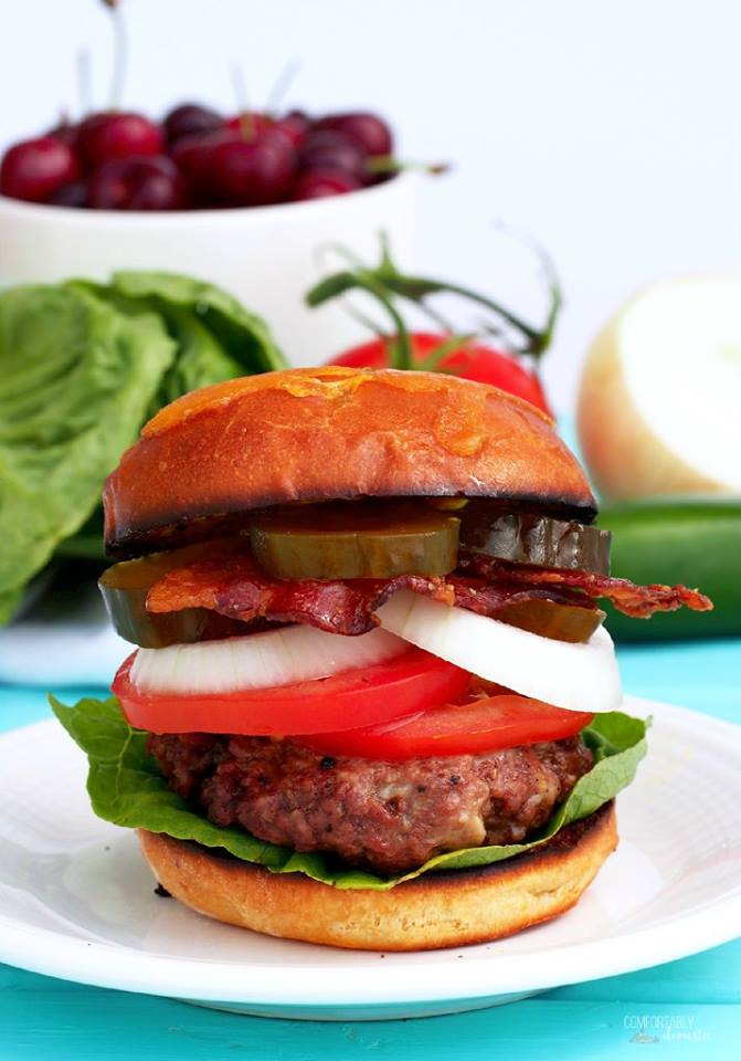 juicy-sweet-heat-burger on a toasted bun with lettuce tomato onion pickle and bacon.