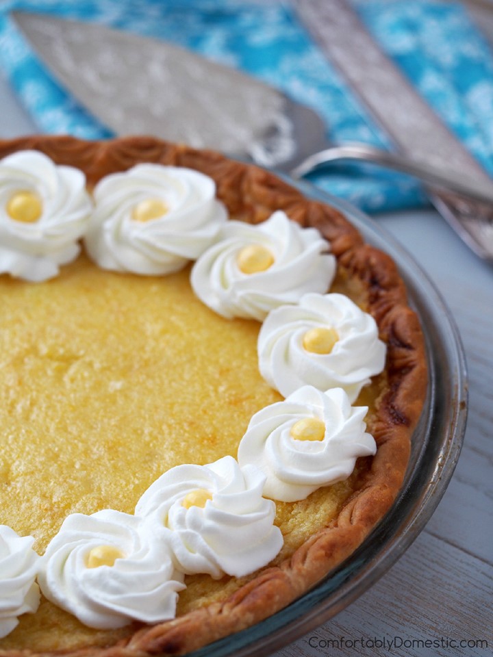 lemon chess pie with whipped cream swirls and yellow candy centers. 